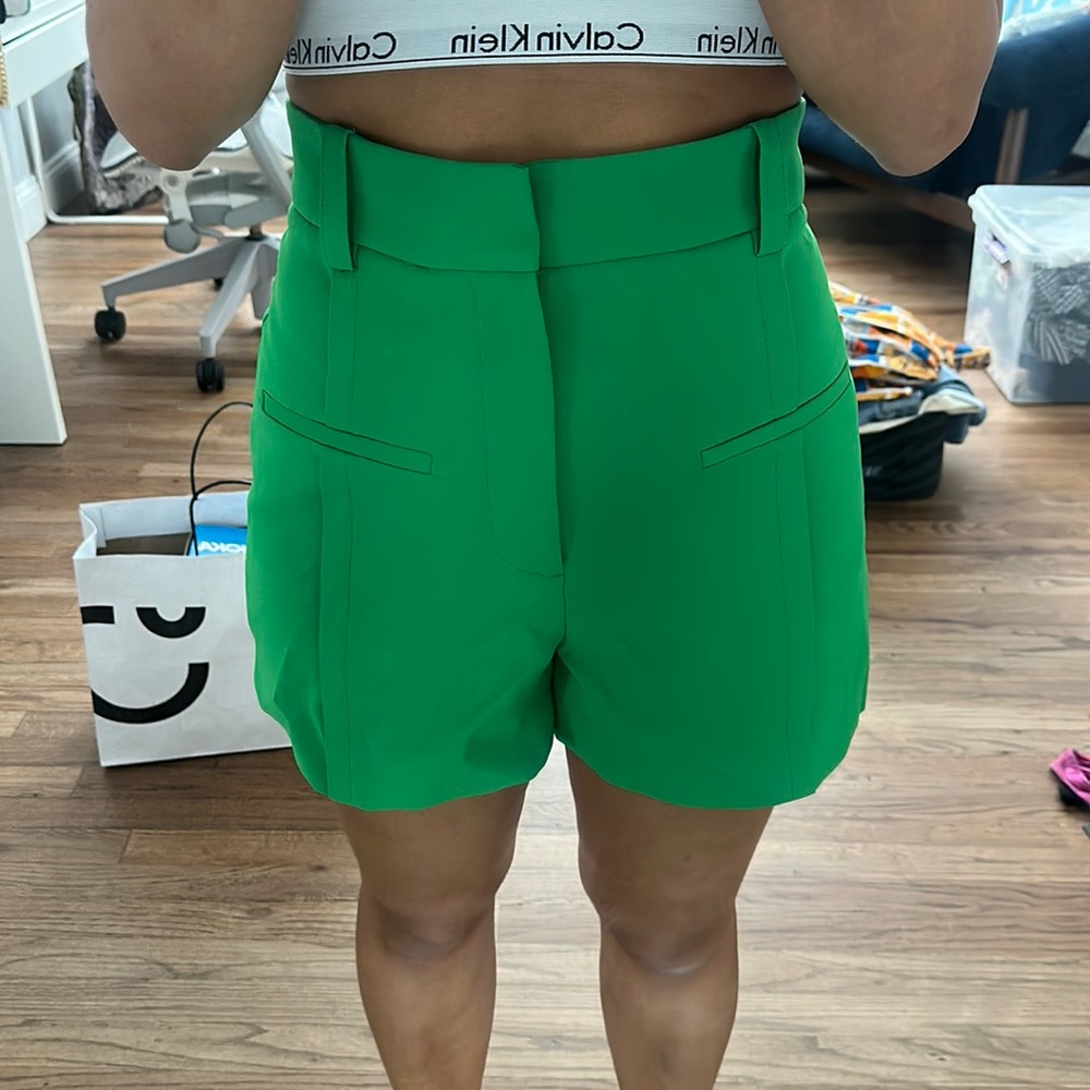 Green shorts with pleats